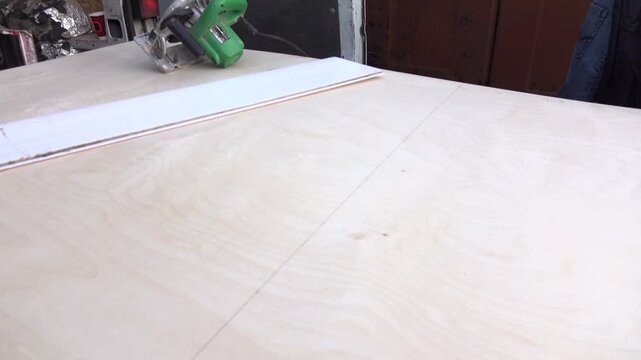 worker measures board for cutting
