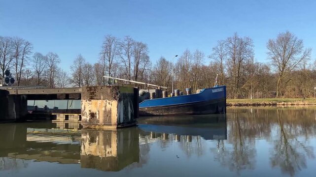 a barge on a water canal near the city of herstel