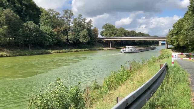 a barge on a water canal near the city of herstel