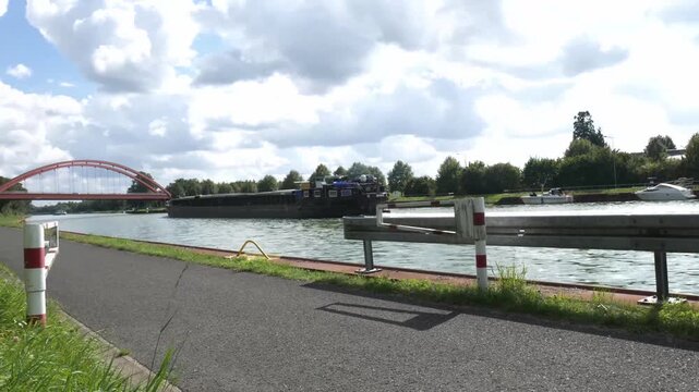 a barge on a water canal near the city of herstel