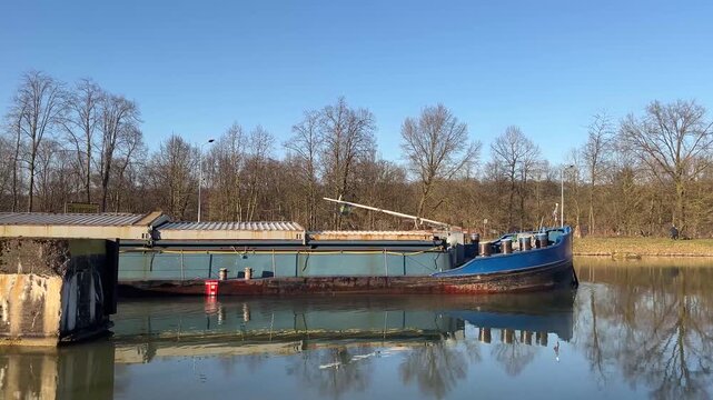 a barge on a water canal near the city of herstel
