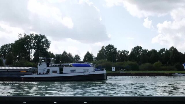 a barge on a water canal near the city of herstel