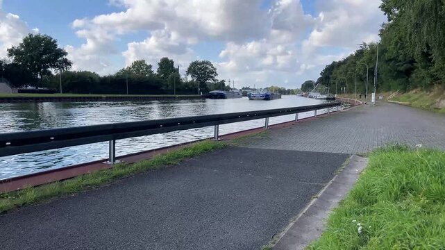 a barge on a water canal near the city of herstel