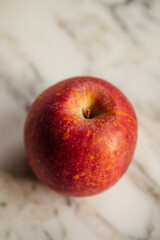 red fuji apple on white marble table