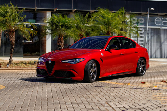 Red Alfa Romeo Giulia Quadrifoglio parked, high-performance italian sports sedan