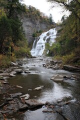 Fototapeta premium Ithaca Falls: Majestic Waterfall Cascading Through Lush Forest Landscape