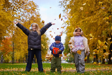 Children enjoy playing in an autumn park