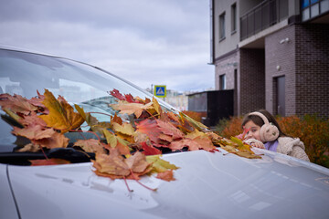 Kids playing with leaves in an autumn park