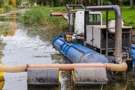 Dredging Machine in a Pond Surrounded by Greenery