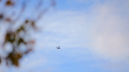 Airplane flies high in the blue sky. Ideal for travel backgrounds