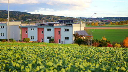 Fototapeta premium Modern apartment building with solar panels. Ideal for illustrating sustainable living concepts