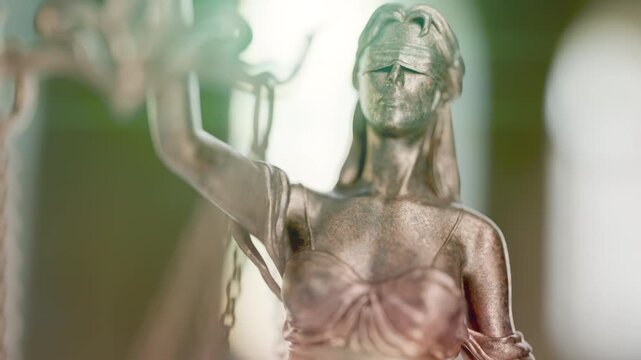 Slow Upward Handheld Crane Movement of Lady Justice Statue In An Office Setting.