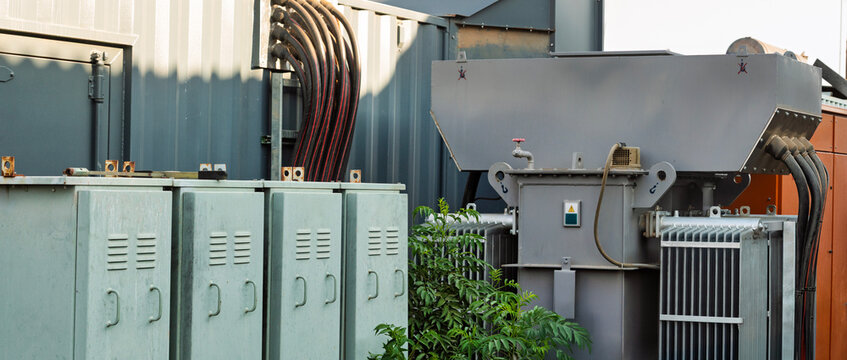 Electrical transformer and switchgear cabinets. Both transformers and switchgear are essential components of an electrical power system