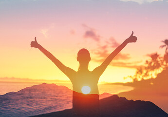 Fototapeta premium Young woman looking up at the morning sun light sky finding happiness, peace and hope in nature 