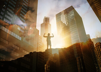 Reaching new heights, victorious man celebrating success on a mountain facing city. Motivational image, overcoming dificulties 