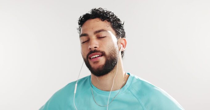 Smile, earphones and man in studio, fitness and wellness on white background. Healthy person, workout and exercise with sound, podcast and listening to music, playlist album or breathing with audio