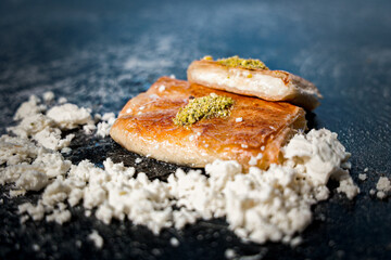 Traditional Palestinian Kulaj Sweet with Cheese  or Walnut Filling and Pistachio Garnish 