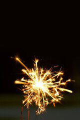 A sparkler is a type of hand held firework that burns slowly while emitting bright, colored sparks
