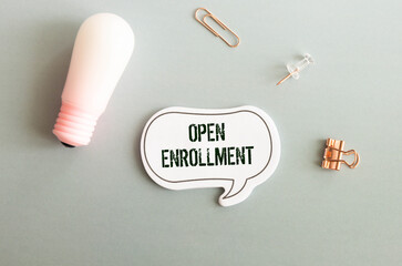 Stethoscope and notepad with text open enrollment Medical concept.