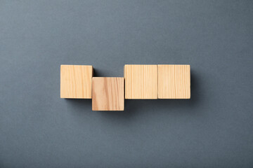 Wooden cubes on grey background, top view