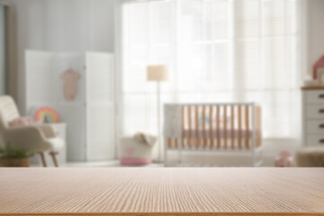 Empty wooden table in baby room. Space for design