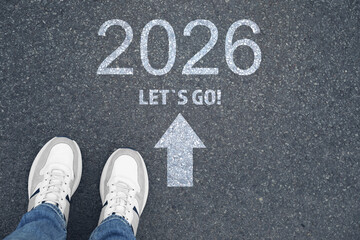 New Year. Man standing near arrow, phrase Let's Go and numbers 2026 on asphalt, top view
