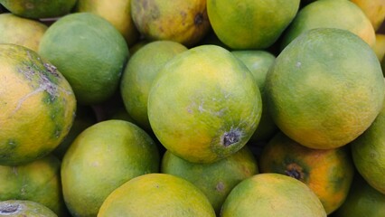 Close up pile of tasty fresh limes sold at the market as a background.