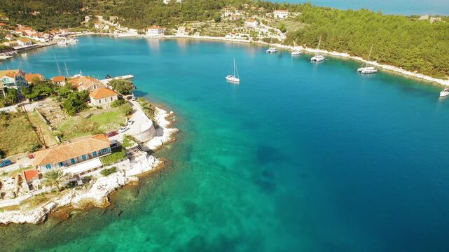 Harbor view of Fiscardo village in Kefalonia Greece with boats and houses
