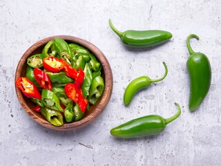  Flat lay of sliced and whole jalapeno peppers.