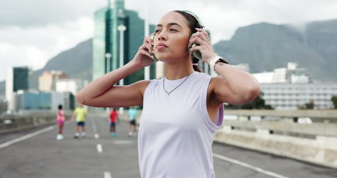 Runner, smart watch and woman in city with headphones for exercise, workout and training for marathon. Sports, fitness and person listening to music, audio and tracker for wellness, health or running