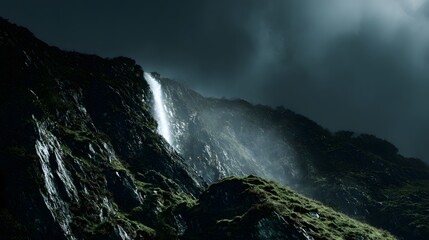 Obraz premium Steep rocky slope features a cascading waterfall under dark, moody skies