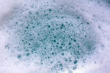 Foamy blue water surface with bubbles.