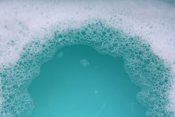 Foamy blue water surface with bubbles.