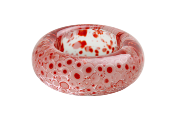 A clear, glass-like object with pink bubbles encircling a white core with red spots