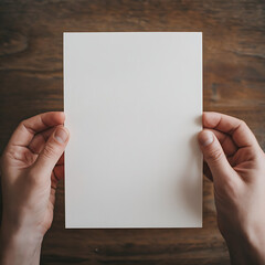 Obraz premium A person is holding a rectangular white paper with no writing, their fingers spread out, and holding it in their hands.