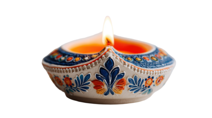 Beautiful decorative clay diya with glowing flame and intricate traditional patterns for Diwali celebration isolated on white background