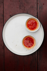 Spicy Red Chili Sauce isolated on White Plate Top View