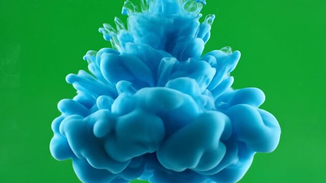 Abstract Blue Ink Cloud Explosion in Water on a Vibrant Green Screen Background for Creative Design Projects