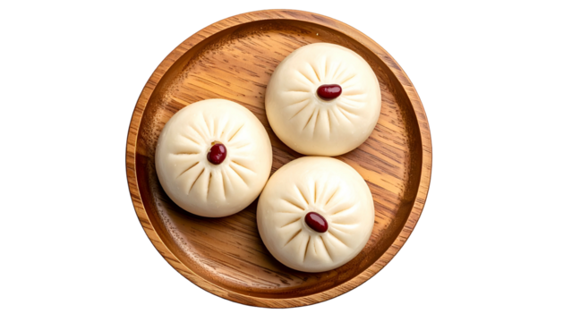 Overhead shot of three steamed buns on a circular wooden plate. Each bun has a red bean on top
