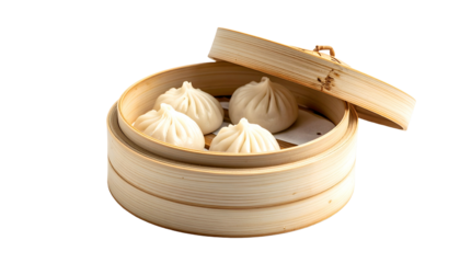 Close-up of four soup dumplings in a bamboo steamer, partially opened lid