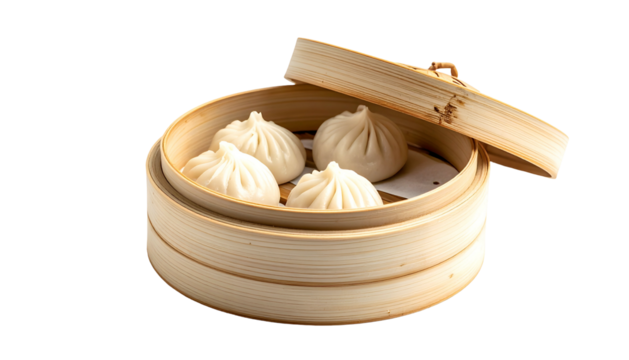 Close-up of four soup dumplings in a bamboo steamer, partially opened lid