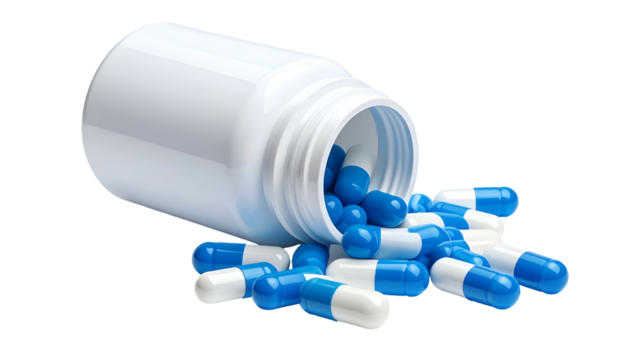 White plastic bottle on its side spills blue and white capsules onto a surface
