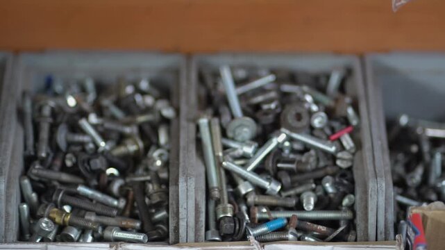 Tool box with cells with screws, anchors, nails, bolts and other tools in workshop