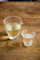 A Glass Measuring Cup and a Small Glass Cup Placed on a Wooden Table
