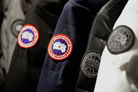 New York, NY - January 22, 2025: Row of Canada Goose brand Arctic Program arm patches on down coats on display at retailer.