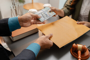 A client hands a stack of cash to a lawyer who holds a brown envelope on the desk, symbolizing bribery, corruption, and unethical financial dealings in a legal or business context.