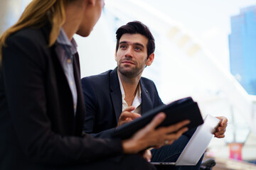 Businessperson discussing data and insurance sales in city.