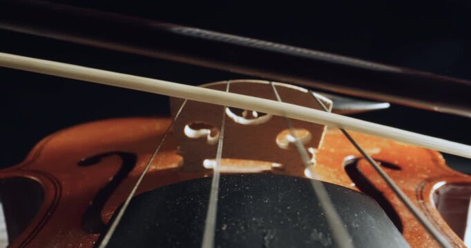 Played on violin with bow moving and strings vibrating in super slow motion