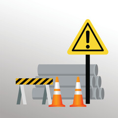 A construction zone is marked with a safety sign, cone, and hard hat