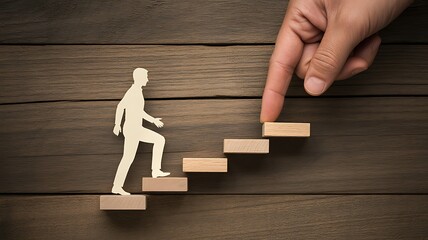 Hand guides paper figure up wooden steps towards success